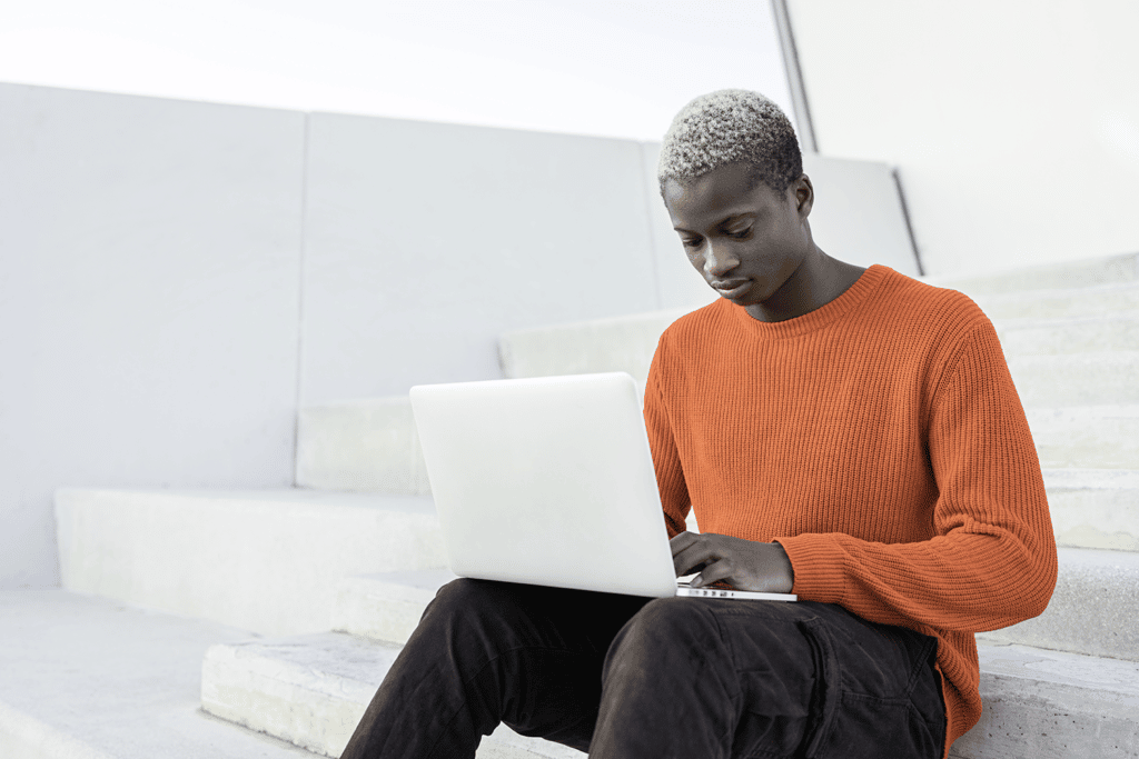 Man on steps on laptop