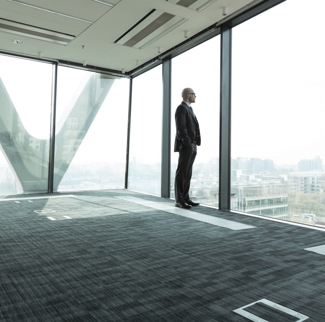 Man in suit looking out the window