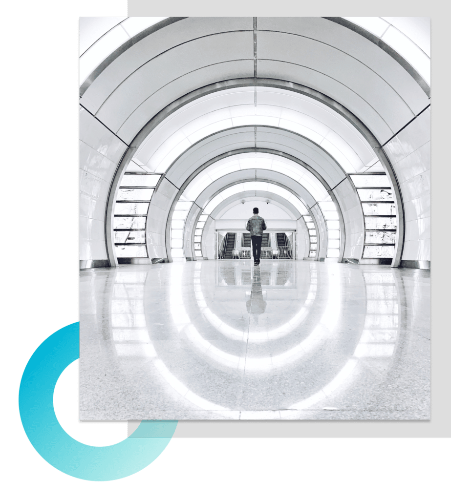 Person walking down a white circular hallway